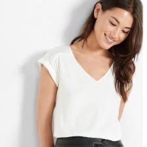 Off-White Satin Blouse with rolled sleeve.